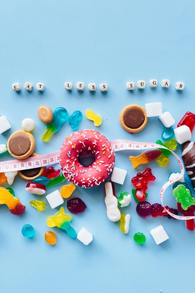 Vibrant display of donuts and candy promoting sugar reduction message.