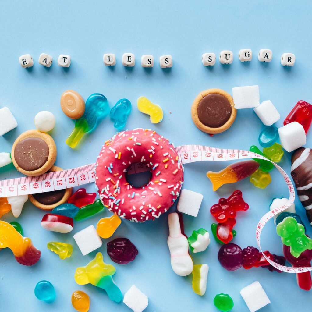Vibrant display of donuts and candy promoting sugar reduction message.